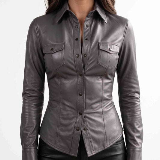 Front close up view of a woman wearing a tailored charcoal gray lambskin leather shirt with snap buttons and flap chest pockets.