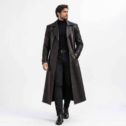 Full length front view of handsome man walking in handmade black genuine leather long trench coat open over dark turtleneck and trousers