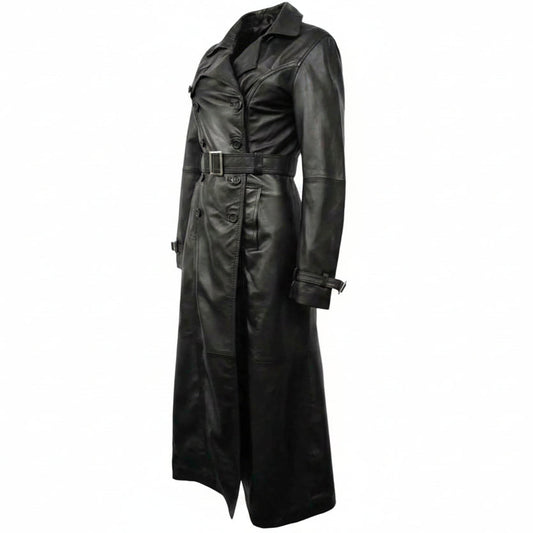 A long black leather trench coat with a double-breasted front, belt, and collar, shown on a plain white background with a circular leather brand watermark over the lower center.