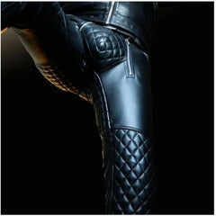 Close-up of a man's black cowhide leather pants featuring a quilted design on the knee area and a visible brand tag.
