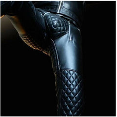 Black leather riding pants with quilted knee and thigh panels, shown on a model against a dark background.