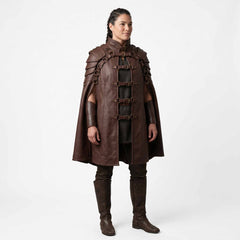 Front three quarter perspective of woman modeling brown leather renaissance warrior cloak showing front buckle straps and high collar
