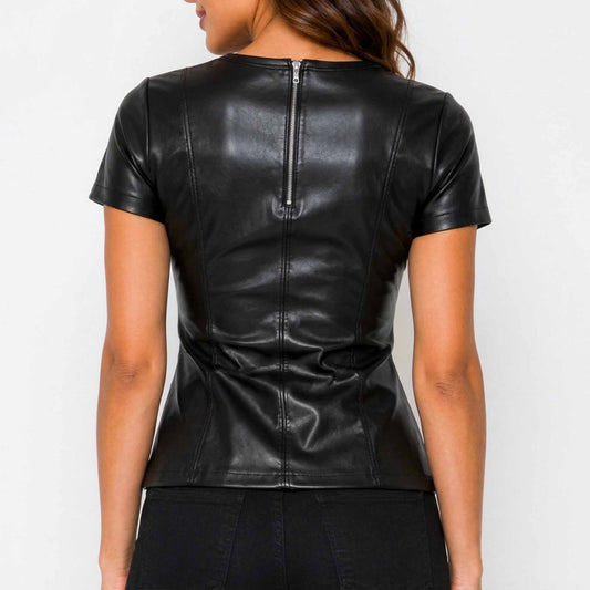 Back view displaying the silver exposed zipper and tailored contour seam lines on a women's black leather short sleeve top.