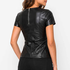 Three quarter back perspective highlighting the waist fit, upper back zipper, and sleeve stitching on a black sheepskin leather blouse.