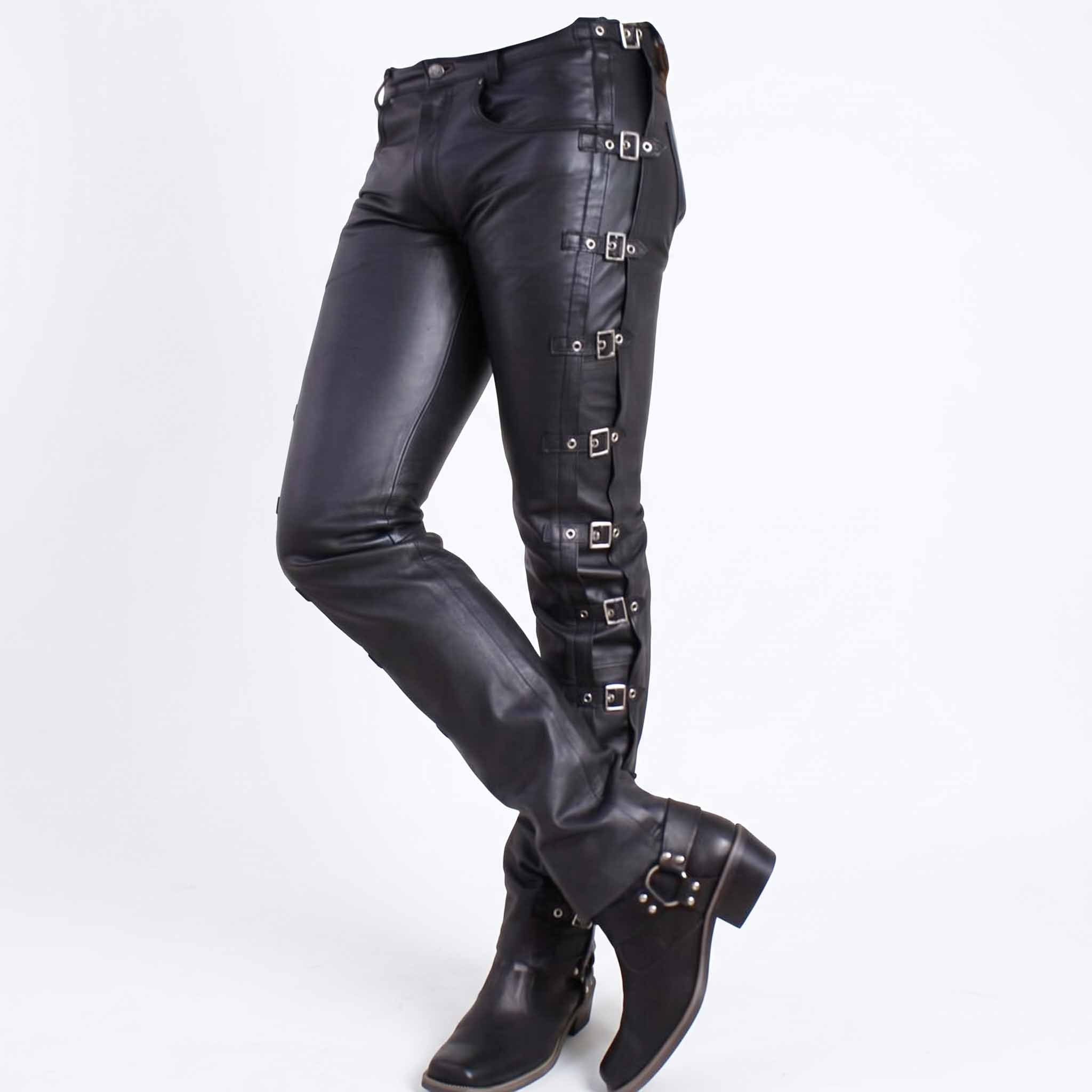 Three quarter perspective of woman wearing slim fit black leather buckle trousers paired with black harness biker boots