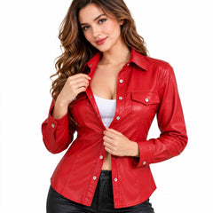 Close up view of a woman adjusting the silver buttons of an unbuttoned red leather shirt layered over a white top.