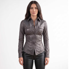 Full front view of a brunette model posing in a fitted dark gray lambskin leather button down shirt paired with black pants.