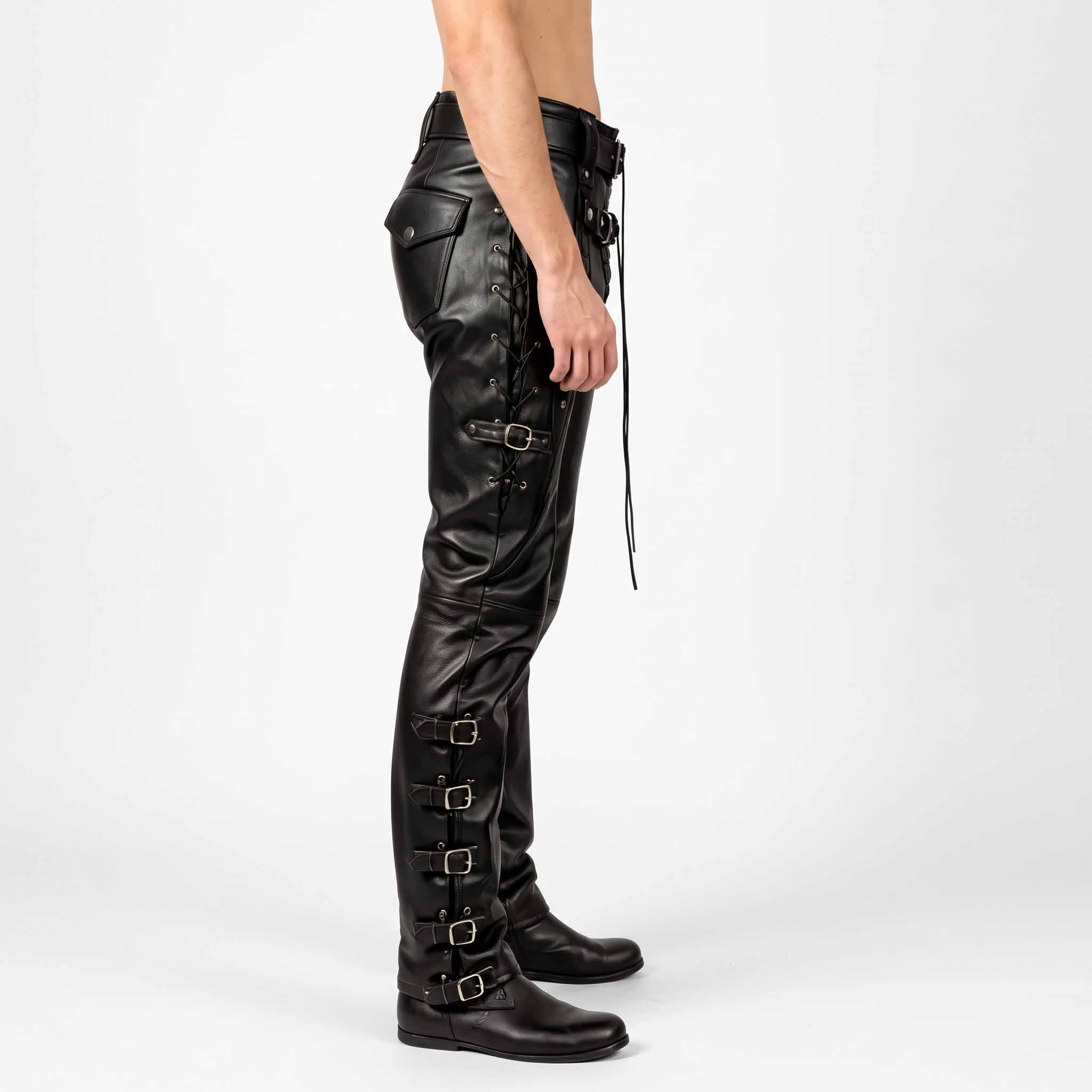 Side profile shot of black leather motorcycle trousers detailing four outer calf buckle straps and side thigh lacing