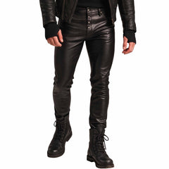 Front close up view of man wearing handmade black real leather jeans with button fly placket and black combat lace up boots