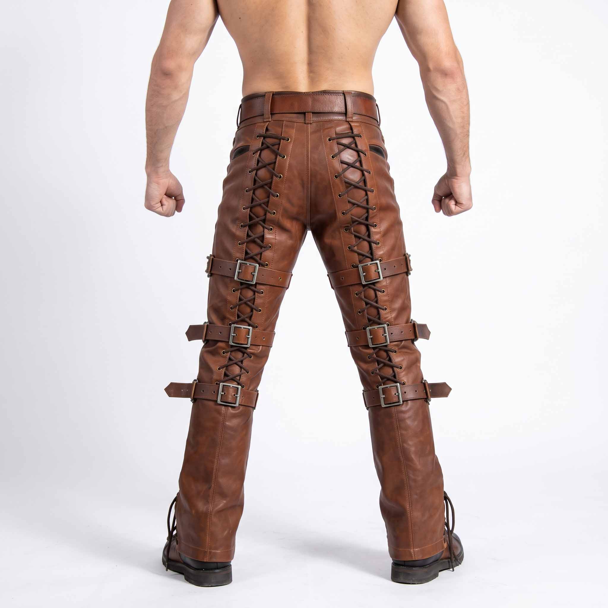 Direct rear view of man showing fit of brown cowhide leather pants with rear spine cord lacing and five pocket waist styling