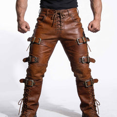 Close up front view of brown cowhide leather pants detailing front lace up fly, studded waistband pockets, and horizontal roller buckles