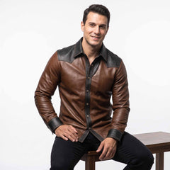 Handsome man seated on wooden bench wearing tailored brown and black leather cowboy shirt displaying curved bottom hem and wrist cuffs