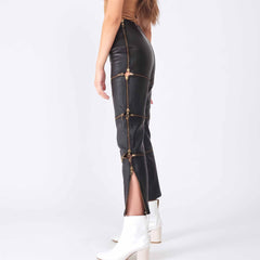 Side profile shot of woman wearing black leather zip off pants showing open side zipper slits and gold zipper pull details