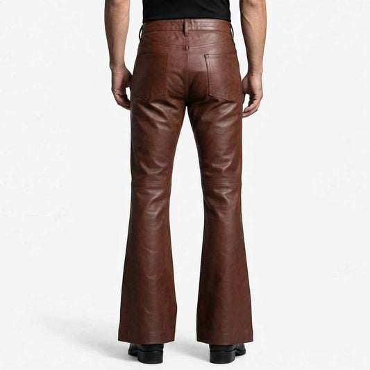 Rear view showcasing the clean back pockets, high waist cut, and wide flared leg opening on black leather trousers.