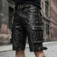 Front three-quarter angle of black leather knee-length shorts highlighting silver grommet thigh lacing, large cargo pocket, and roller buckle strap