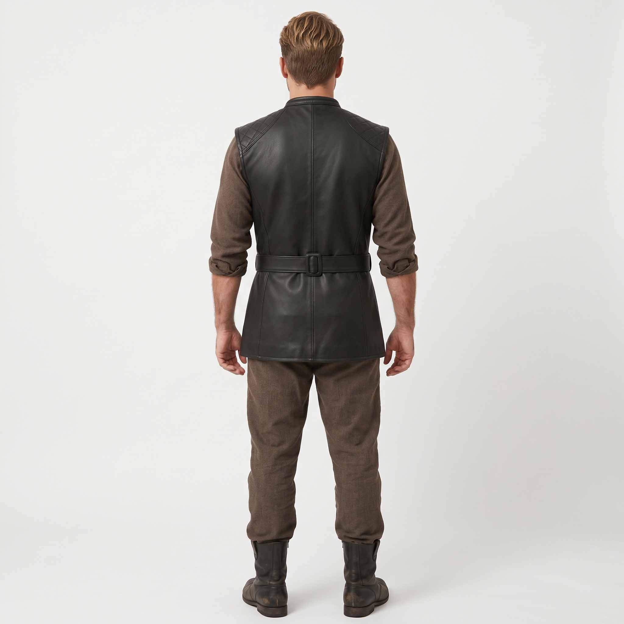 Full length back view of male model in handmade black leather long waistcoat paired with brown wool trousers and dark leather boots