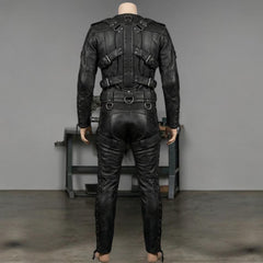 Workshop rear view of handmade black leather bondage suit on tailor form displaying reinforced lumbar waistband and spinal harness detailing