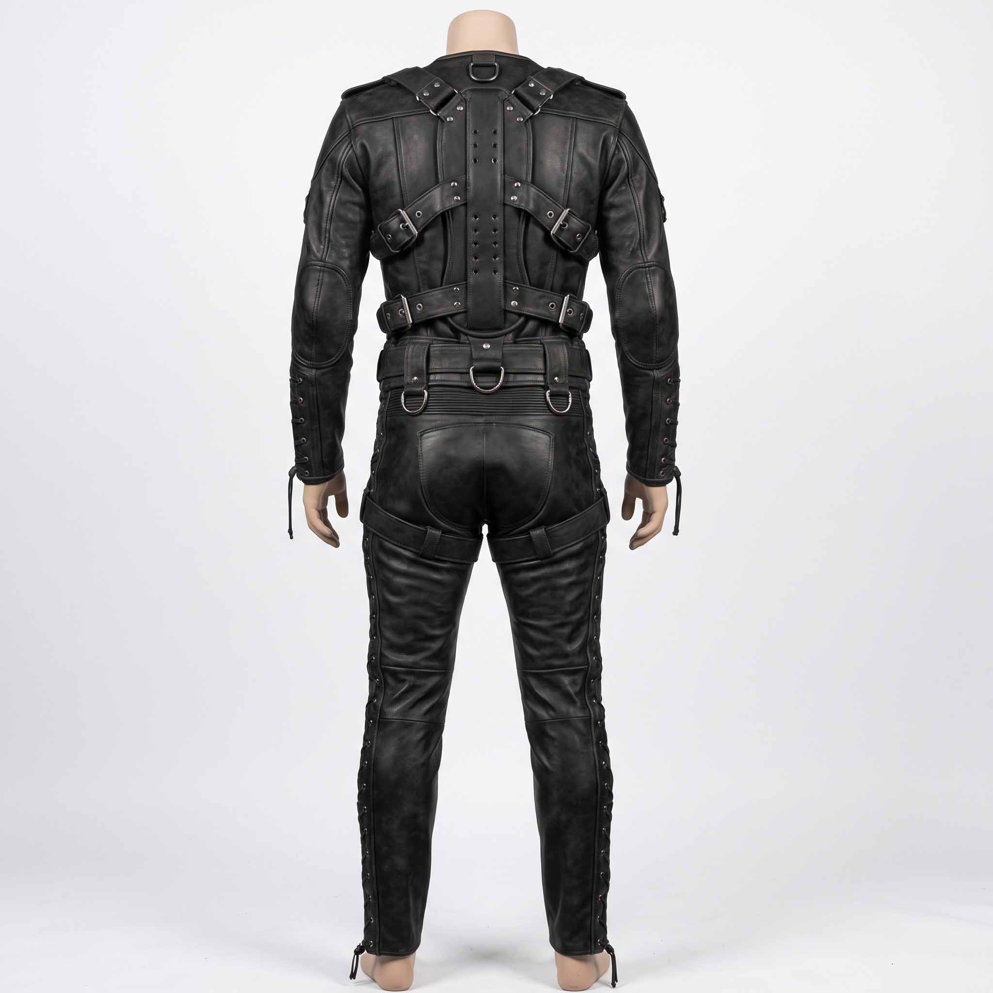 Back studio view of black leather bondage suit on mannequin displaying symmetrical back buckle straps, D rings, and outer leg cord eyelets