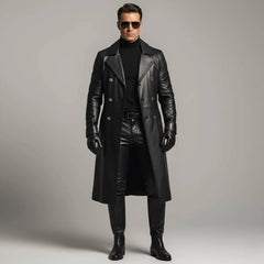 ide profile view of handsome man wearing handmade full-length black leather trench coat and boots against grey background
