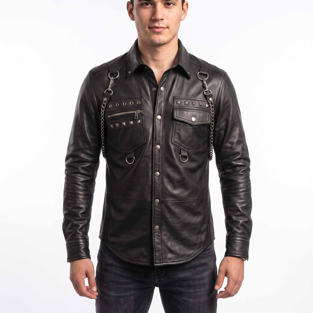 Full front view of handsome young man wearing handmade black sheepskin leather shirt with silver studs, shoulder chains, and snap button placket