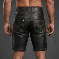 Rear view of tailored black leather shorts showing dual back pockets with chevron stitching, wide belt loops, and smooth cowhide finish.