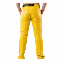 Rear angle view of a man wearing yellow full-grain cowhide 501 style leather pants showing back pockets and waistline.