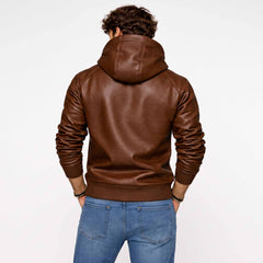 Back view of man wearing tailored brown leather hoodie showing clean back yoke, hood drape, and ribbed waistband over blue jeans