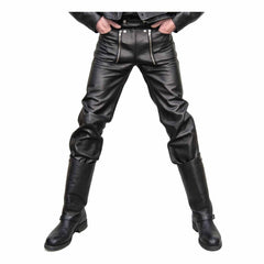 Front view of a man wearing black cowhide leather carpenter pants tucked into tall leather biker boots.