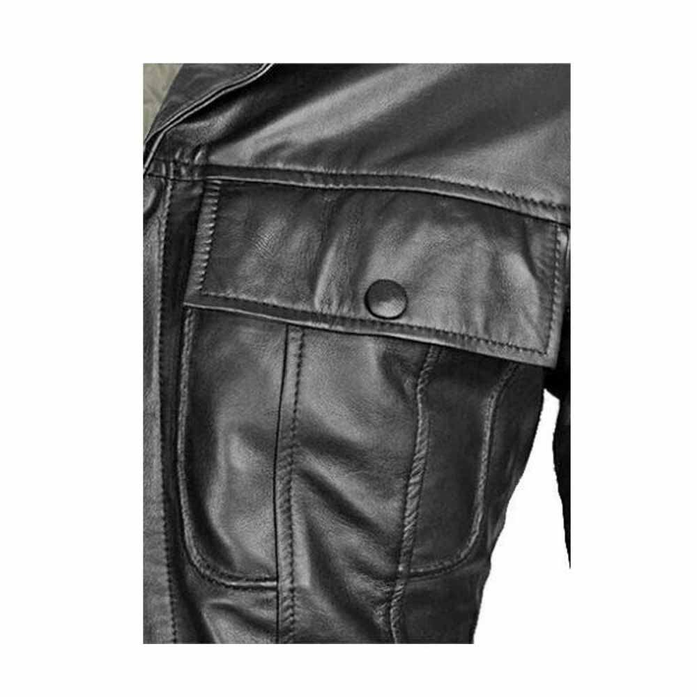 Close-up view of the snap-button chest flap pocket and double-stitched seams on a black lambskin leather jacket.