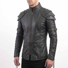 Front three-quarter view of man wearing tailored black leather larp shirt highlighting front metal zipper and structured leather shoulder pauldrons