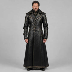 Full length studio portrait of bearded man wearing handmade black leather gothic studded duster coat with high collar and buckle straps on grey background