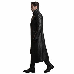 Side profile 90 degree studio view of man modeling tailored black leather duster trench coat and black leather boots