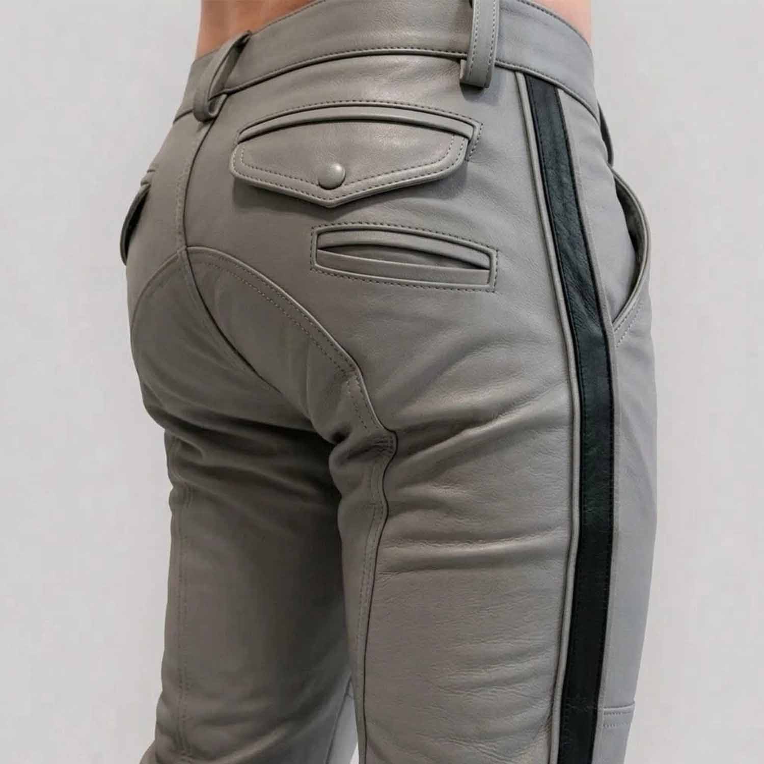 Close-up rear view of a man wearing gray  cowhide leather breeches with a crisp black side stripe, featuring buttoned rear flap pockets and custom paneling.