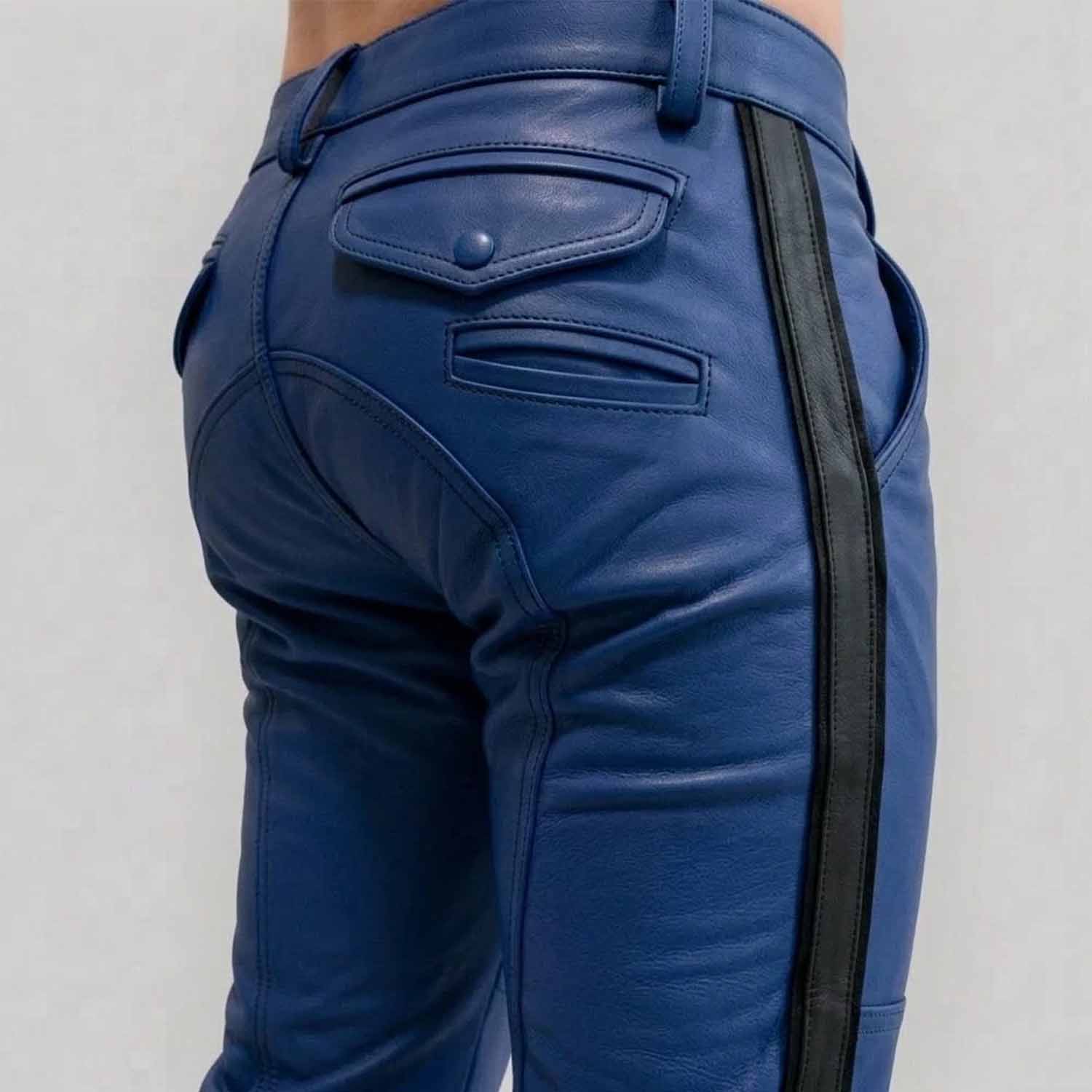 Close-up rear view of a man wearing royal blue cowhide leather breeches with a crisp black side stripe, featuring buttoned rear flap pockets and custom paneling.