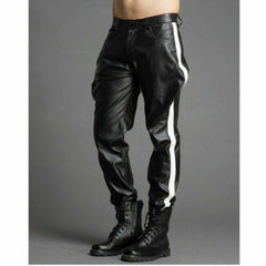 Front angle view of men's black top-grain leather breeches featuring a white side stripe, flared thigh cut, and black tactical boots.