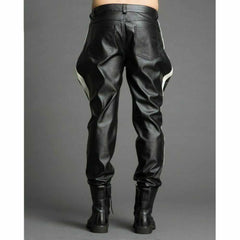 Rear view of men's black cowhide leather breeches showing dual back patch pockets, white side panel stripes, and tapered leg cuffs.