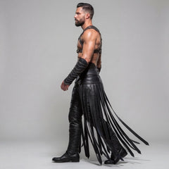 Side profile angle of man walking forward showcasing trailing long leather fringe panels, segmented leg armor ridges, and buckled chest harness