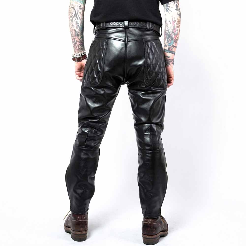 Back view of men's black cowhide leather biker pants showcasing diamond-quilted upper seat panels and double-stitched back seams.