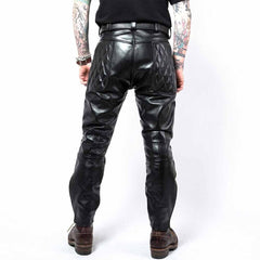 Back view of men's black cowhide leather biker pants showcasing diamond-quilted upper seat panels and double-stitched back seams.