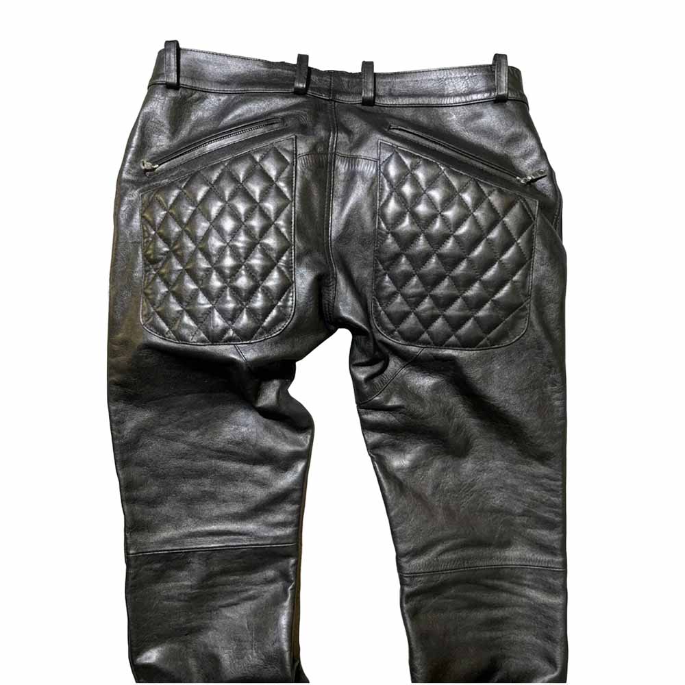 Rear view of men's black leather trousers featuring quilted back pockets and belt loops.