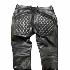 Rear view of men's black leather trousers featuring quilted back pockets and belt loops.