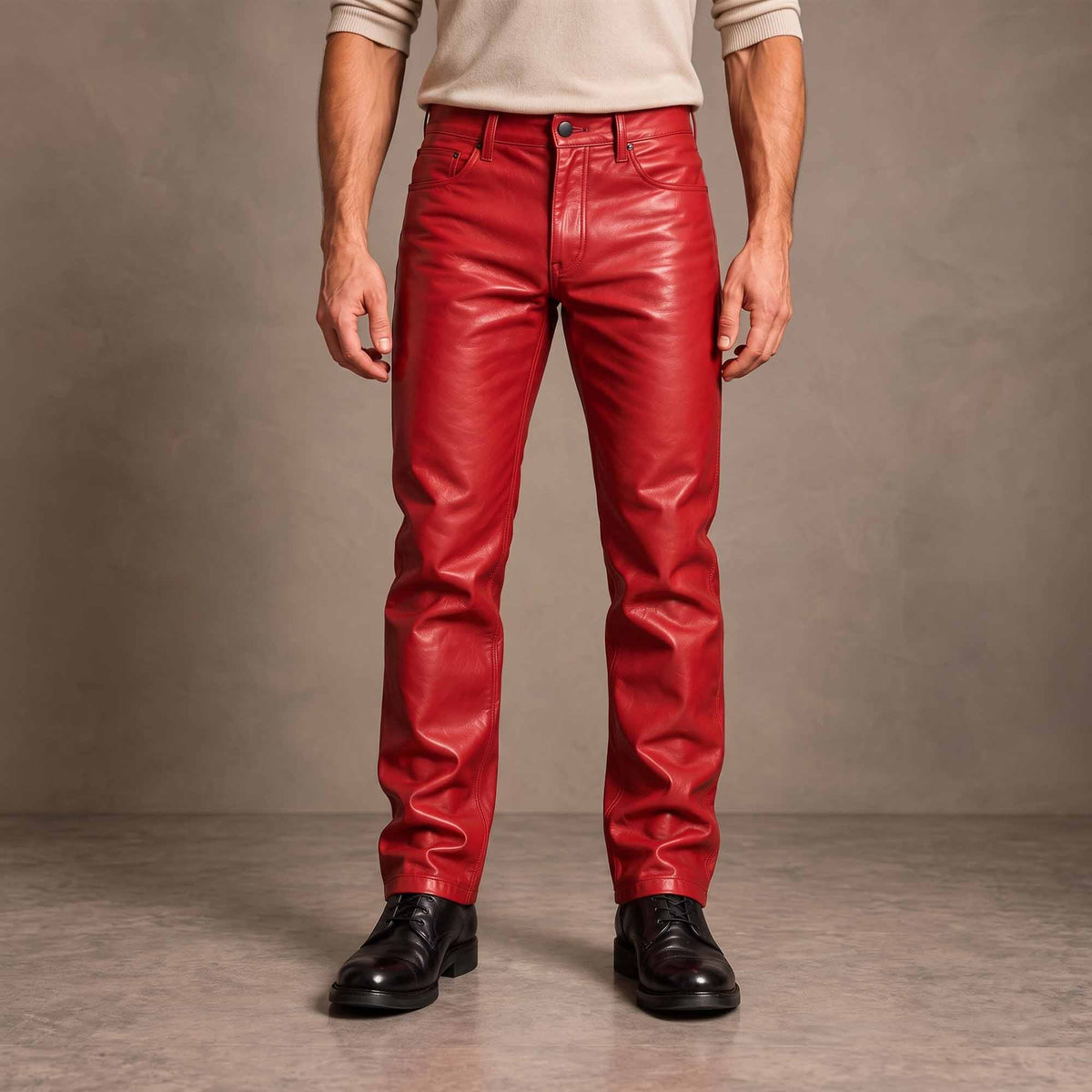 Full-length front view of man wearing tailored royal red cowhide leather slim bootcut pants with black dress boots