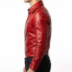 Side profile 90 degree studio view of fitted red leather shirt showing structured sleeve seams and zipper cuff detail
