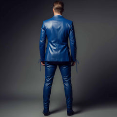 Rear full body view of mens tailored royal blue leather suit showing structured shoulder lines and slim fit trousers