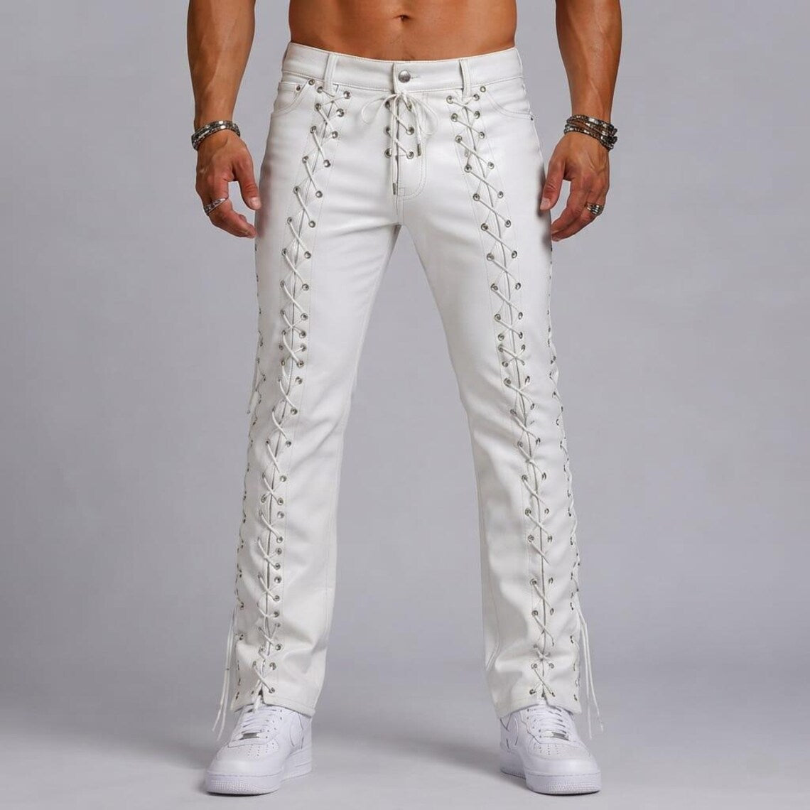Front full-length shot of model wearing men's white genuine cowhide leather pants featuring front lace-up fly ties and straight-leg fit.