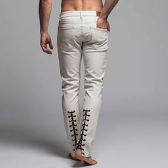 Back three quarter view of mens white leather pants showing five pocket jean construction and lower calf corset lacing