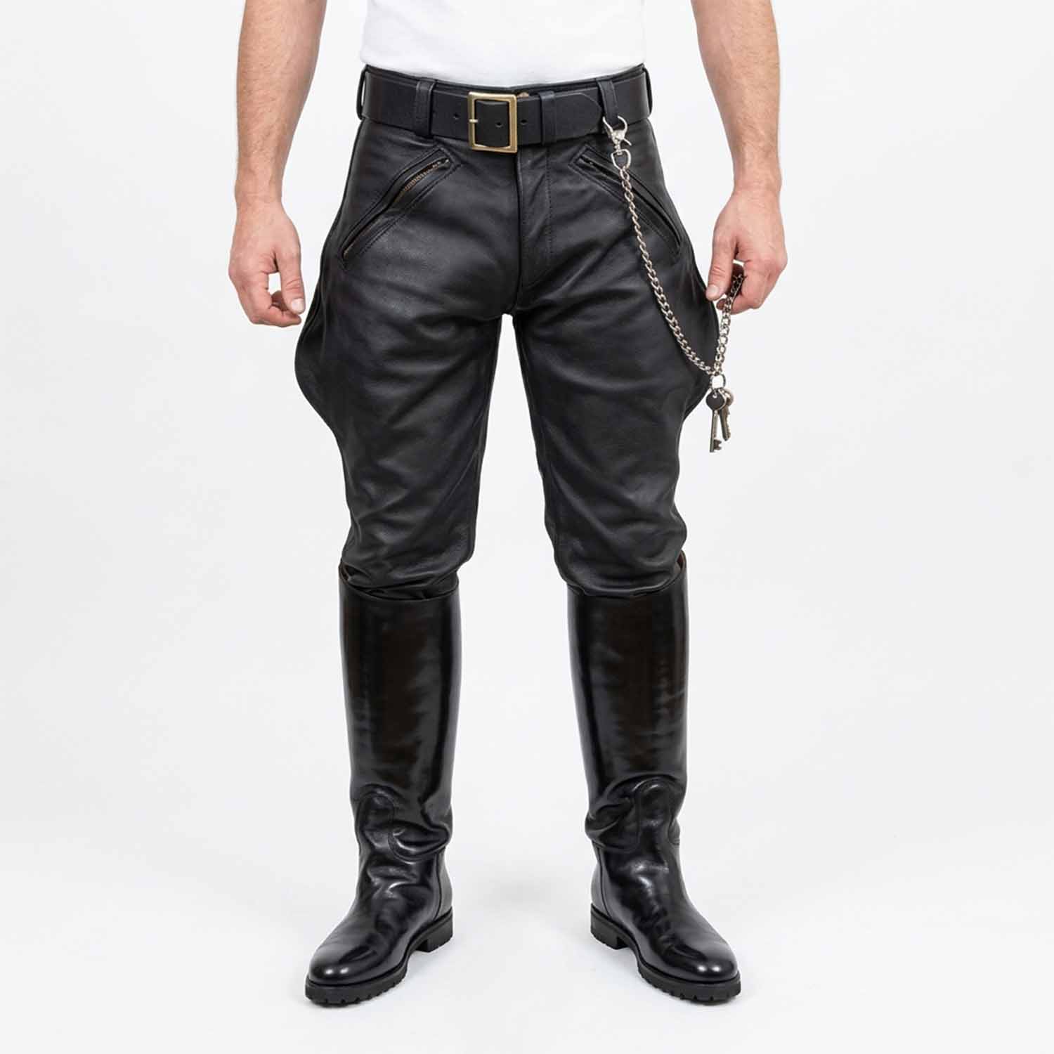 Front view of men wearing black real cowhide leather breeches with front zip pockets, belt, key chain, and tall black leather boots against a white background.