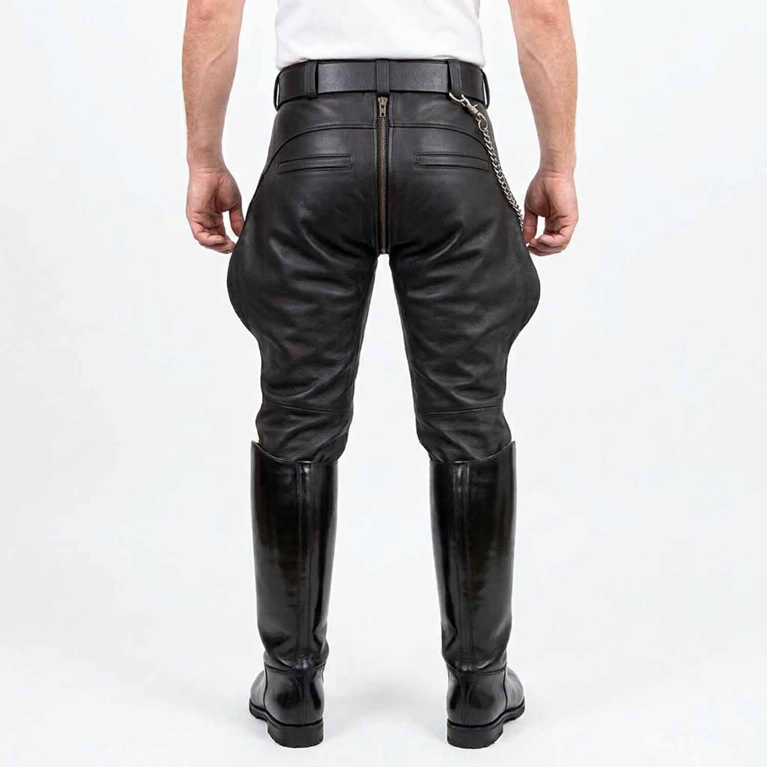 Rear view of men wearing black cowhide leather breeches showing full-length center rear zipper, hidden zipper back pockets, and tall boots against a white background.