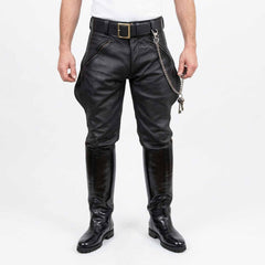 Front view of men wearing black real cowhide leather breeches with front zip pockets, belt, key chain, and tall black leather boots against a white background.