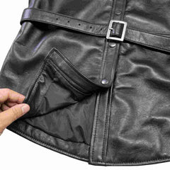 Close up of the smooth interior satin lining and hem finish on a handcrafted black genuine leather shirt.